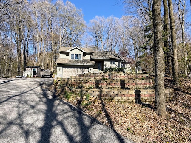 N8673 Ridge Creek Rd, Elkhart Lake, WI 53020 - view of property exterior with asphalt driveway and a garage
