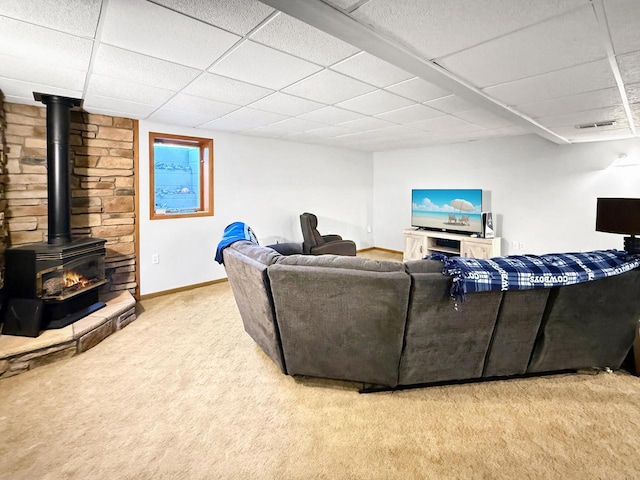 N8673 Ridge Creek Rd, Elkhart Lake, WI 53020 - living area featuring a paneled ceiling, a wood stove, carpet floors, and baseboards