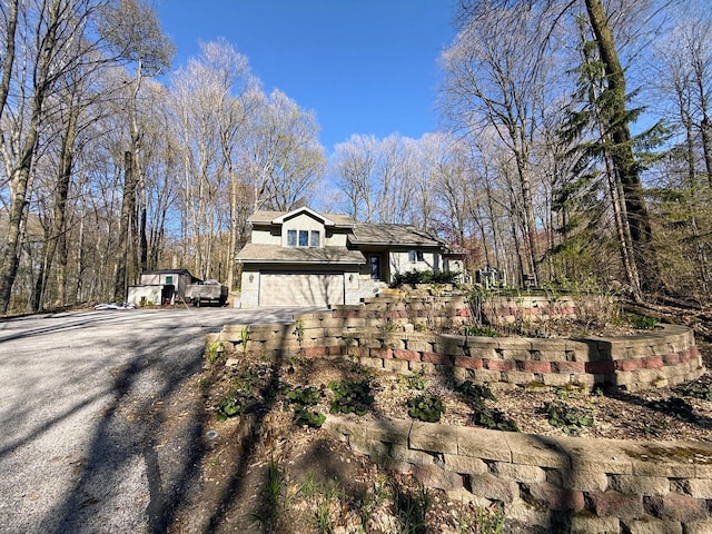 N8673 Ridge Creek Rd, Elkhart Lake, WI 53020 - view of front facade featuring asphalt driveway and an attached garage