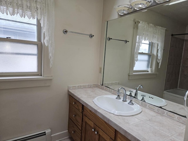 3513 Washington Ave, Racine, WI 53405 - full bath featuring a baseboard heating unit, vanity, and tub / shower combination