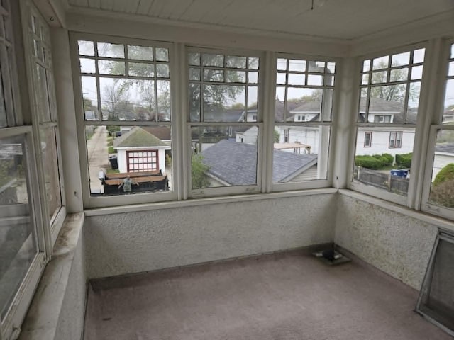 3513 Washington Ave, Racine, WI 53405 - unfurnished sunroom featuring carpet flooring and a textured wall