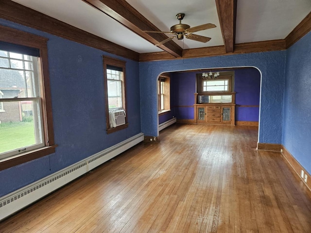 3513 Washington Ave, Racine, WI 53405 - empty room with arched walkways, baseboard heating, baseboards, wood-type flooring, and beam ceiling