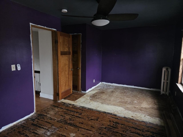 3513 Washington Ave, Racine, WI 53405 - empty room with ceiling fan, radiator, baseboards, and a smoke detector