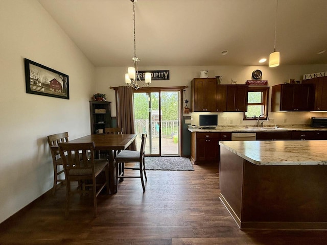 520 Alyssa St, Tomah, WI 54660 - kitchen featuring light countertops, dark wood-style flooring, a chandelier, tasteful backsplash, and a sink