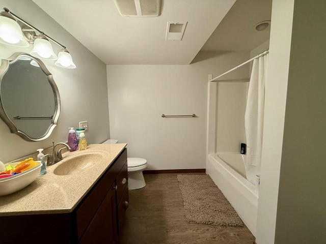 520 Alyssa St, Tomah, WI 54660 - bathroom with wood finished floors, vanity, toilet, shower / tub combo with curtain, and baseboards