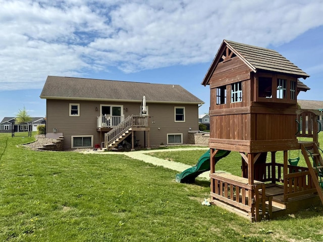 520 Alyssa St, Tomah, WI 54660 - back of property featuring a playground, stairway, a yard, and a wooden deck