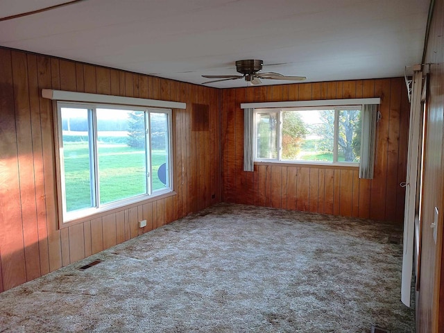 5544 Elm Rd, Pittsville, WI 54466 - carpeted empty room with plenty of natural light, ceiling fan, and wood walls
