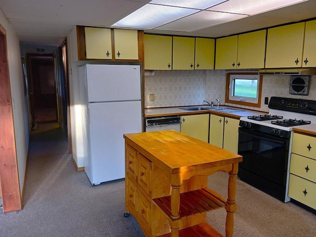 5544 Elm Rd, Pittsville, WI 54466 - kitchen with white appliances, a sink, light carpet, yellow cabinets, and light countertops