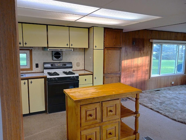 5544 Elm Rd, Pittsville, WI 54466 - kitchen with range with gas cooktop, light colored carpet, butcher block counters, wood walls, and extractor fan