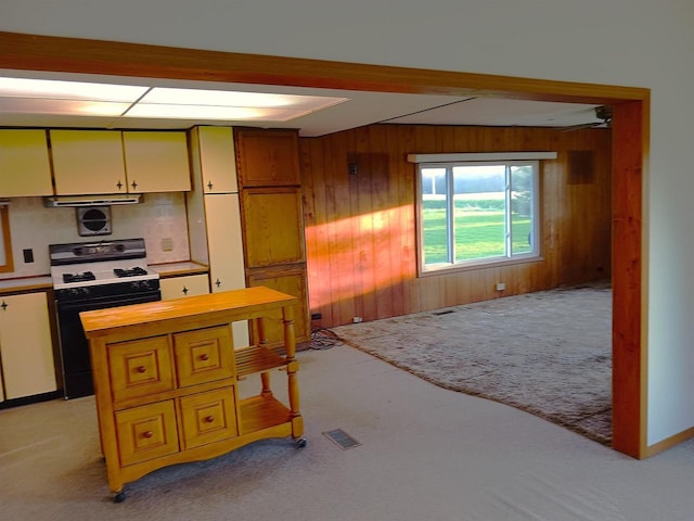 5544 Elm Rd, Pittsville, WI 54466 - kitchen with range with gas stovetop, light colored carpet, butcher block countertops, wood walls, and ventilation hood