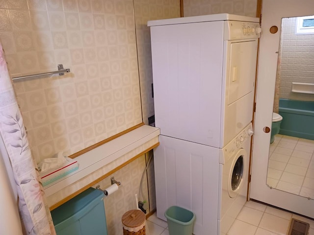 5544 Elm Rd, Pittsville, WI 54466 - laundry area featuring stacked washer / drying machine and light tile patterned floors