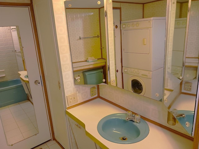 5544 Elm Rd, Pittsville, WI 54466 - bathroom with stacked washer and clothes dryer, tile patterned flooring, and vanity