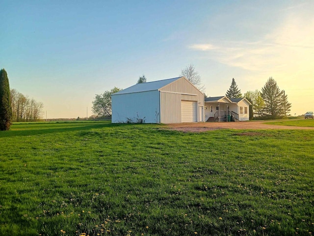 5544 Elm Rd, Pittsville, WI 54466 - yard at dusk with a lawn, an outbuilding, a pole building, and driveway