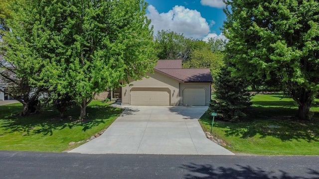 obstructed view of property featuring a front yard and concrete driveway