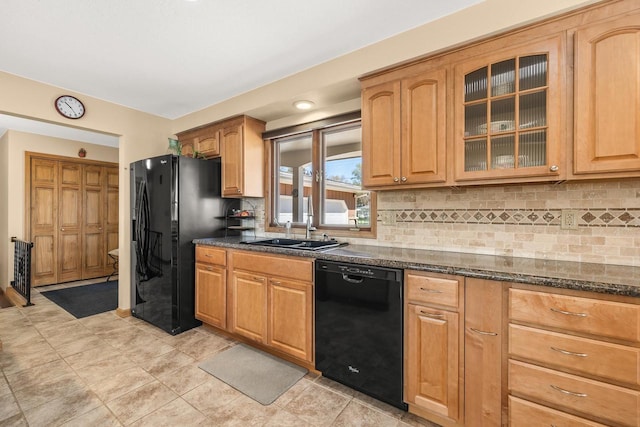 528 Park Ave, Waupaca, WI 54981 - kitchen featuring black appliances, a sink, glass insert cabinets, tasteful backsplash, and dark stone counters