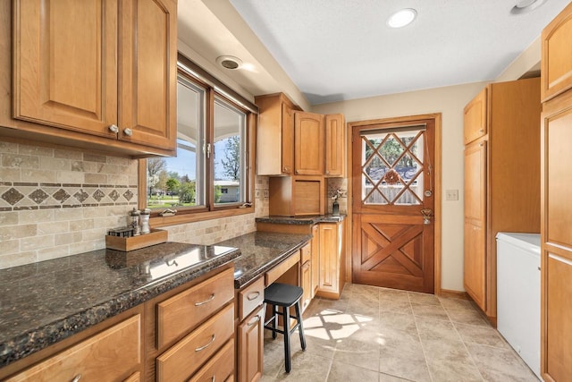 528 Park Ave, Waupaca, WI 54981 - kitchen with dark stone counters, decorative backsplash, and recessed lighting