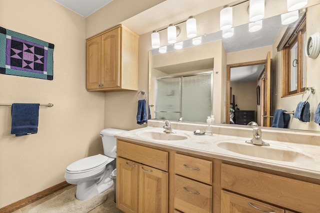 528 Park Ave, Waupaca, WI 54981 - bathroom featuring toilet, a shower stall, double vanity, and baseboards