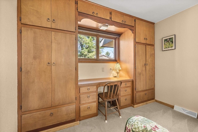 528 Park Ave, Waupaca, WI 54981 - home office with built in study area, baseboards, and light colored carpet