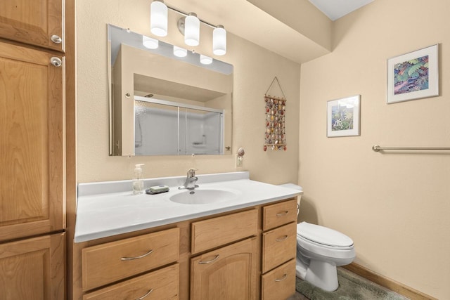 528 Park Ave, Waupaca, WI 54981 - bathroom featuring toilet, vanity, and a shower stall