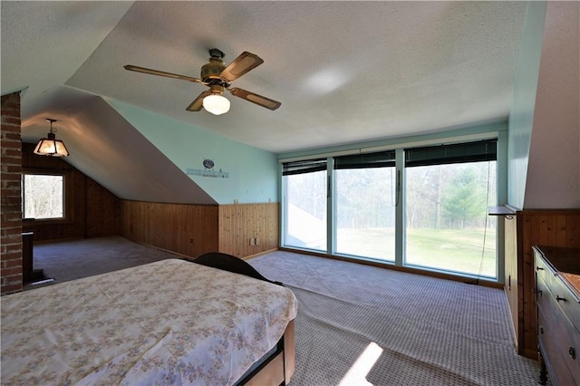 7266 County Road U, Danbury, WI 54830 - bedroom with wooden walls, carpet floors, a textured ceiling, wainscoting, and a ceiling fan