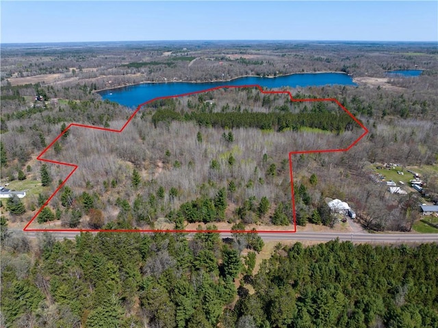 7266 County Road U, Danbury, WI 54830 - aerial view of property and surrounding area with a nearby body of water, property boundaries highlighted, and a heavily wooded area