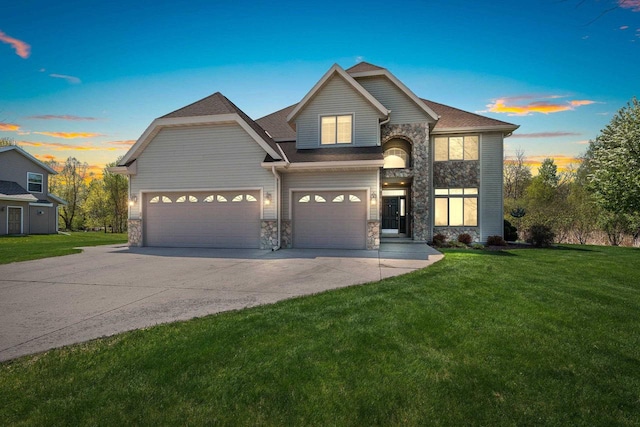W6928 Westwood Dr, Fond Du Lac, WI 54937 - view of front of home with stone siding, concrete driveway, a yard, and a garage