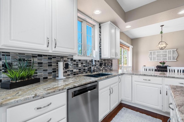 W6928 Westwood Dr, Fond Du Lac, WI 54937 - kitchen featuring stainless steel dishwasher, a sink, white cabinetry, dark wood-type flooring, and backsplash