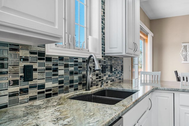 W6928 Westwood Dr, Fond Du Lac, WI 54937 - kitchen with a sink, decorative backsplash, and white cabinets