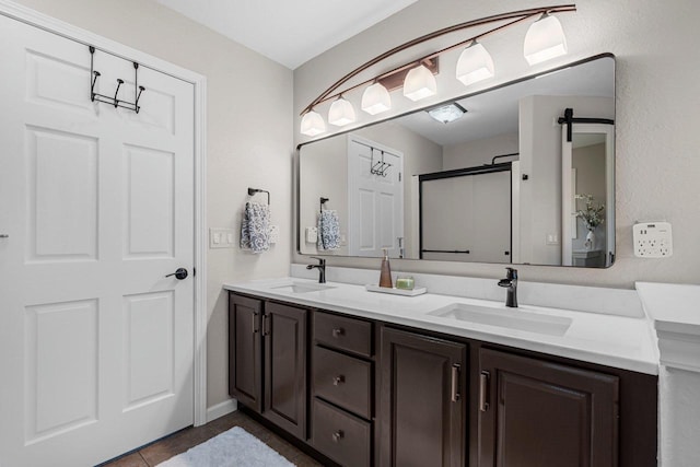 W6928 Westwood Dr, Fond Du Lac, WI 54937 - bathroom featuring double vanity, a shower stall, tile patterned flooring, and baseboards