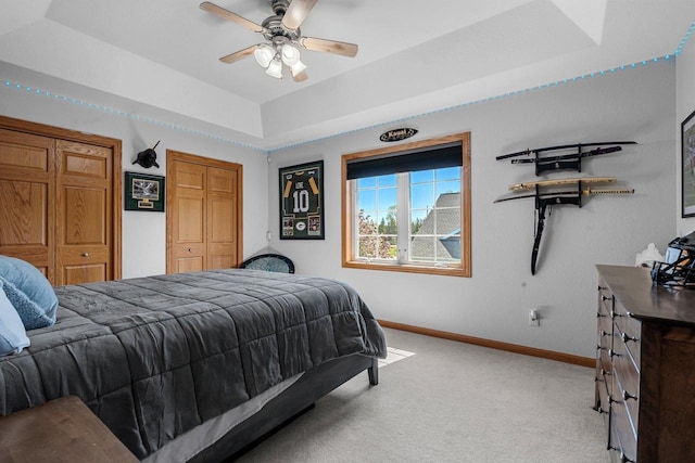 W6928 Westwood Dr, Fond Du Lac, WI 54937 - carpeted bedroom featuring baseboards, a tray ceiling, and a ceiling fan