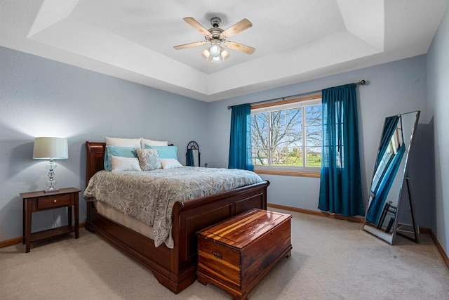 W6928 Westwood Dr, Fond Du Lac, WI 54937 - bedroom with a tray ceiling, light carpet, and baseboards