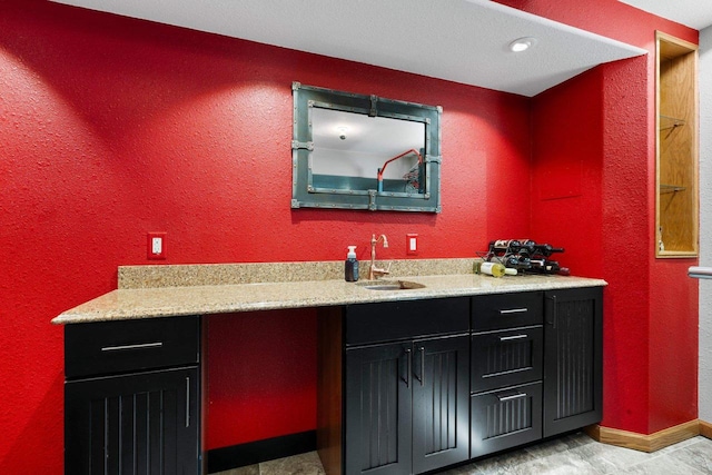 W6928 Westwood Dr, Fond Du Lac, WI 54937 - indoor wet bar with a textured wall and baseboards