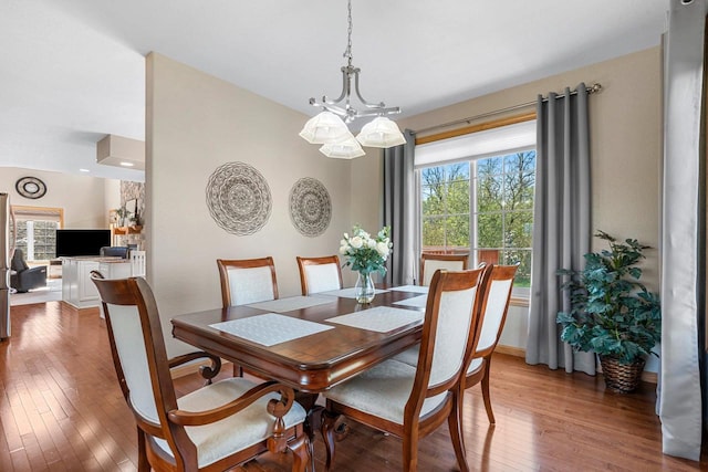 W6928 Westwood Dr, Fond Du Lac, WI 54937 - dining area featuring hardwood / wood-style floors, a chandelier, and baseboards