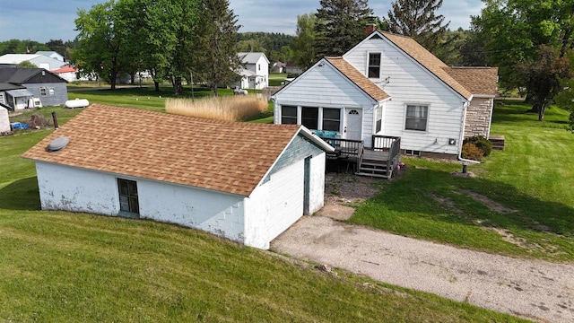 5869 State Highway 27, Sparta, WI 54656 - back of property featuring a deck, a lawn, a chimney, and roof with shingles