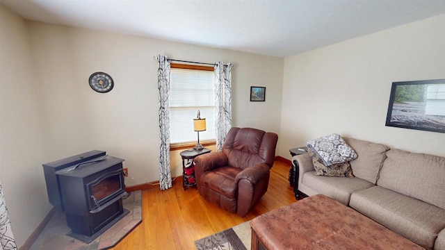 5869 State Highway 27, Sparta, WI 54656 - living room with light wood-type flooring, baseboards, and a wood stove