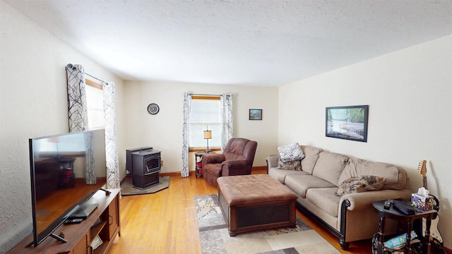 5869 State Highway 27, Sparta, WI 54656 - living area featuring a wood stove, healthy amount of natural light, and light wood-style floors