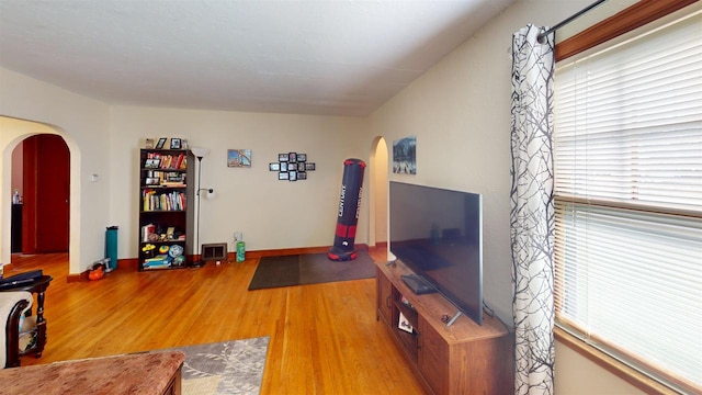 5869 State Highway 27, Sparta, WI 54656 - living area with arched walkways, plenty of natural light, and wood finished floors