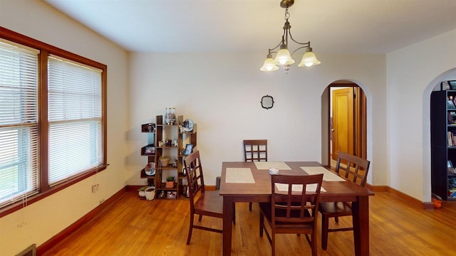 5869 State Highway 27, Sparta, WI 54656 - dining space with arched walkways, light wood-type flooring, and baseboards