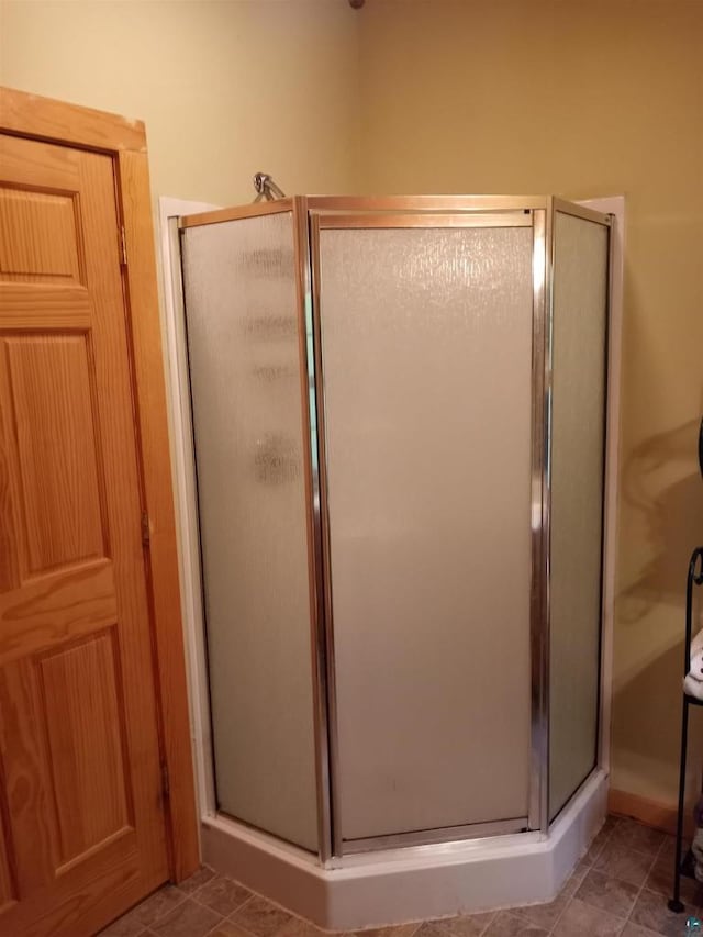 23540 State Highway 13, Cornucopia, WI 54827 - bathroom with a stall shower and tile patterned floors