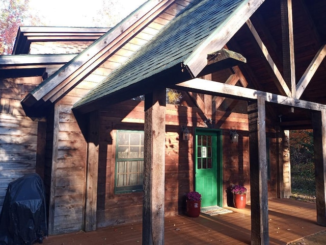 23540 State Highway 13, Cornucopia, WI 54827 - view of side of property featuring a shingled roof and a deck