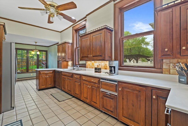 2837 N Marietta Ave, Milwaukee, WI 53211 - kitchen with freestanding refrigerator, light tile patterned floors, a sink, light countertops, and ornamental molding