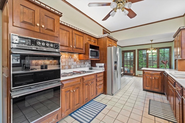 2837 N Marietta Ave, Milwaukee, WI 53211 - kitchen with appliances with stainless steel finishes, crown molding, light tile patterned flooring, brown cabinetry, and tasteful backsplash
