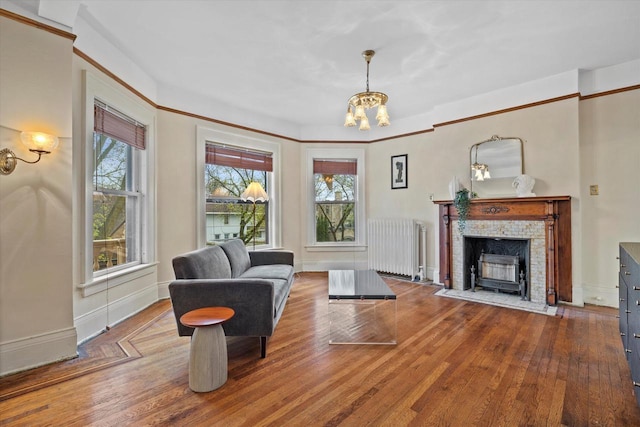 2837 N Marietta Ave, Milwaukee, WI 53211 - living room with radiator heating unit, plenty of natural light, a chandelier, and wood finished floors