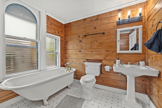 2837 N Marietta Ave, Milwaukee, WI 53211 - full bathroom with tile patterned floors, a freestanding tub, wooden walls, and toilet