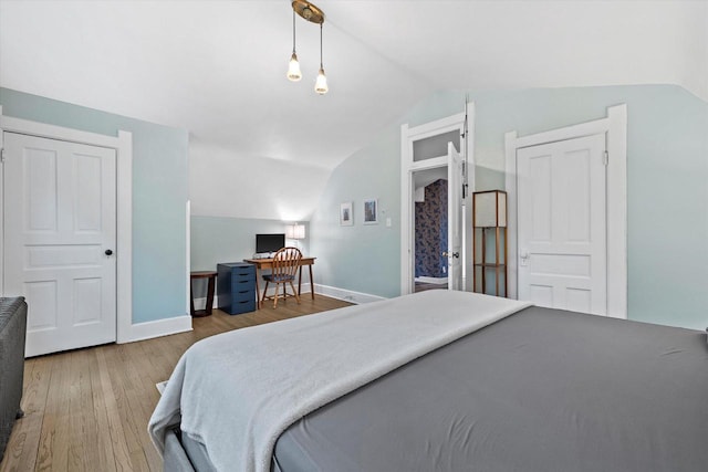 2837 N Marietta Ave, Milwaukee, WI 53211 - bedroom with lofted ceiling, wood finished floors, a desk, and baseboards