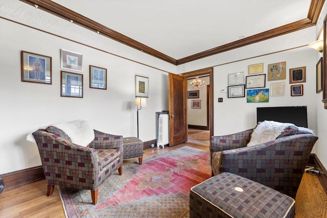 304 16th St, Racine, WI 53403 - living room featuring radiator heating unit, wood finished floors, a chandelier, crown molding, and baseboards