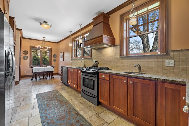 304 16th St, Racine, WI 53403 - kitchen featuring appliances with stainless steel finishes, a sink, premium range hood, stone tile flooring, and crown molding