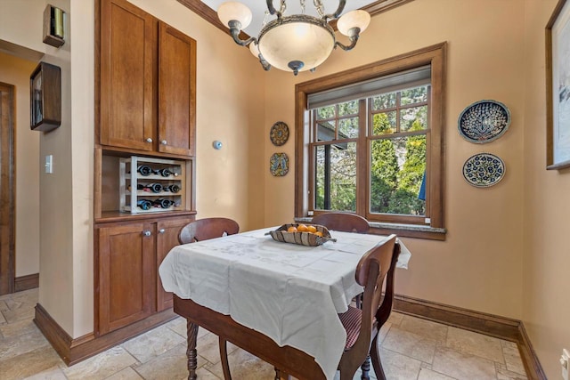 304 16th St, Racine, WI 53403 - dining room with stone tile floors, baseboards, and a chandelier