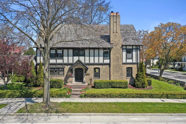 304 16th St, Racine, WI 53403 - tudor house with a chimney and brick siding