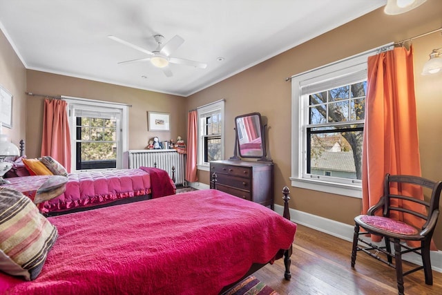 304 16th St, Racine, WI 53403 - bedroom with multiple windows, wood finished floors, ornamental molding, baseboards, and ceiling fan